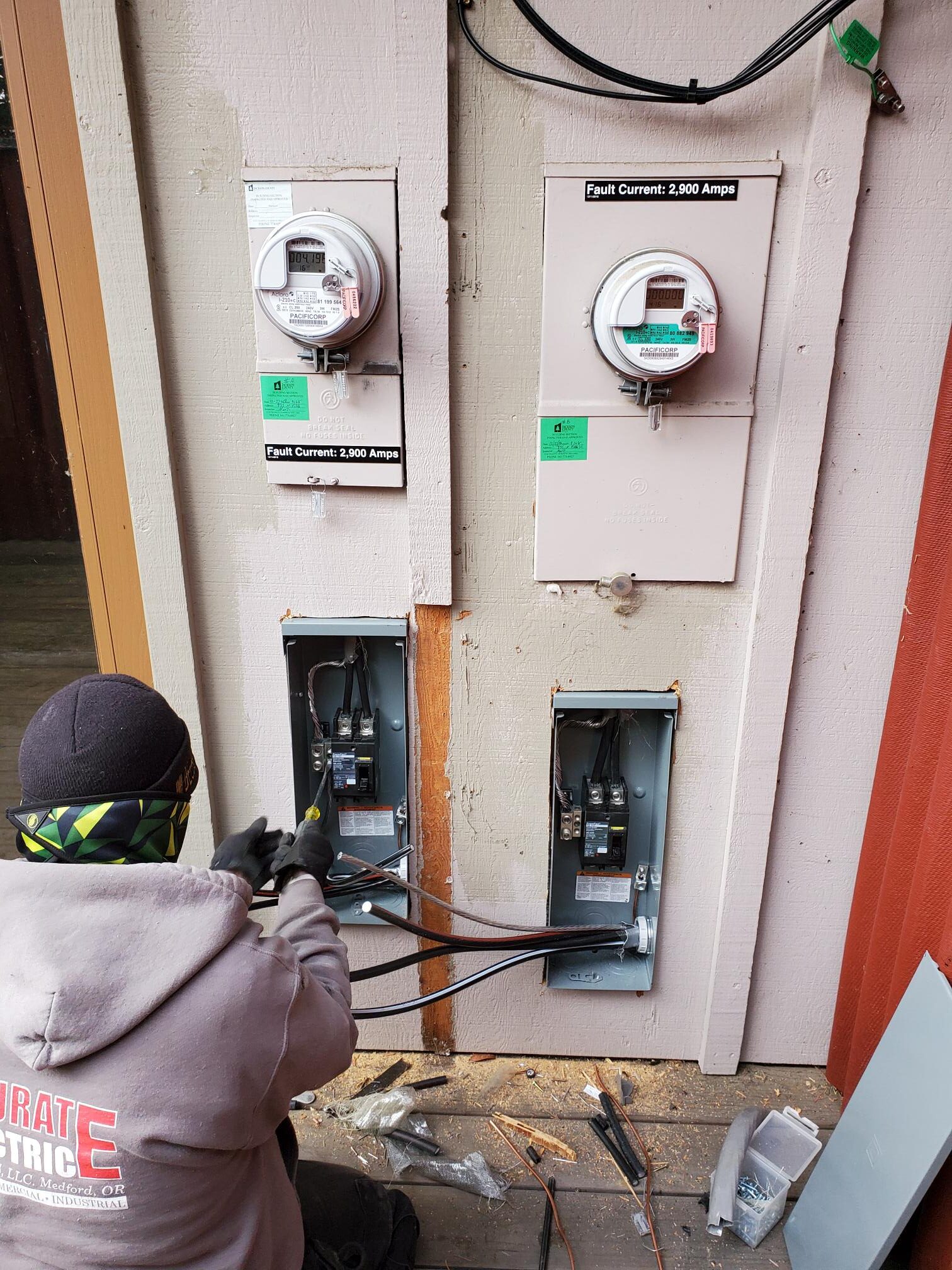 Electrician working on exterior electrical meter and service equipment