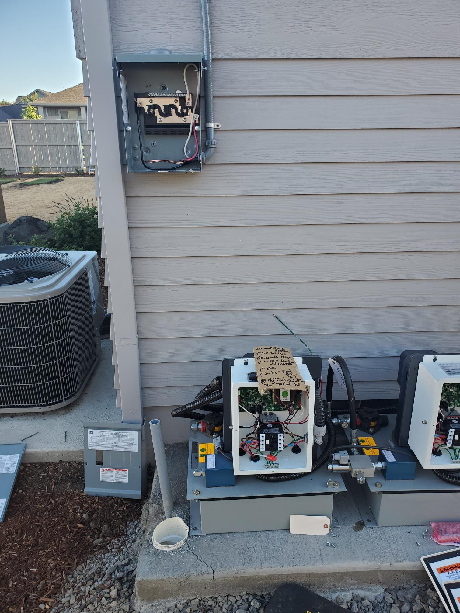 Outdoor HVAC electrical disconnects and control equipment mounted on siding