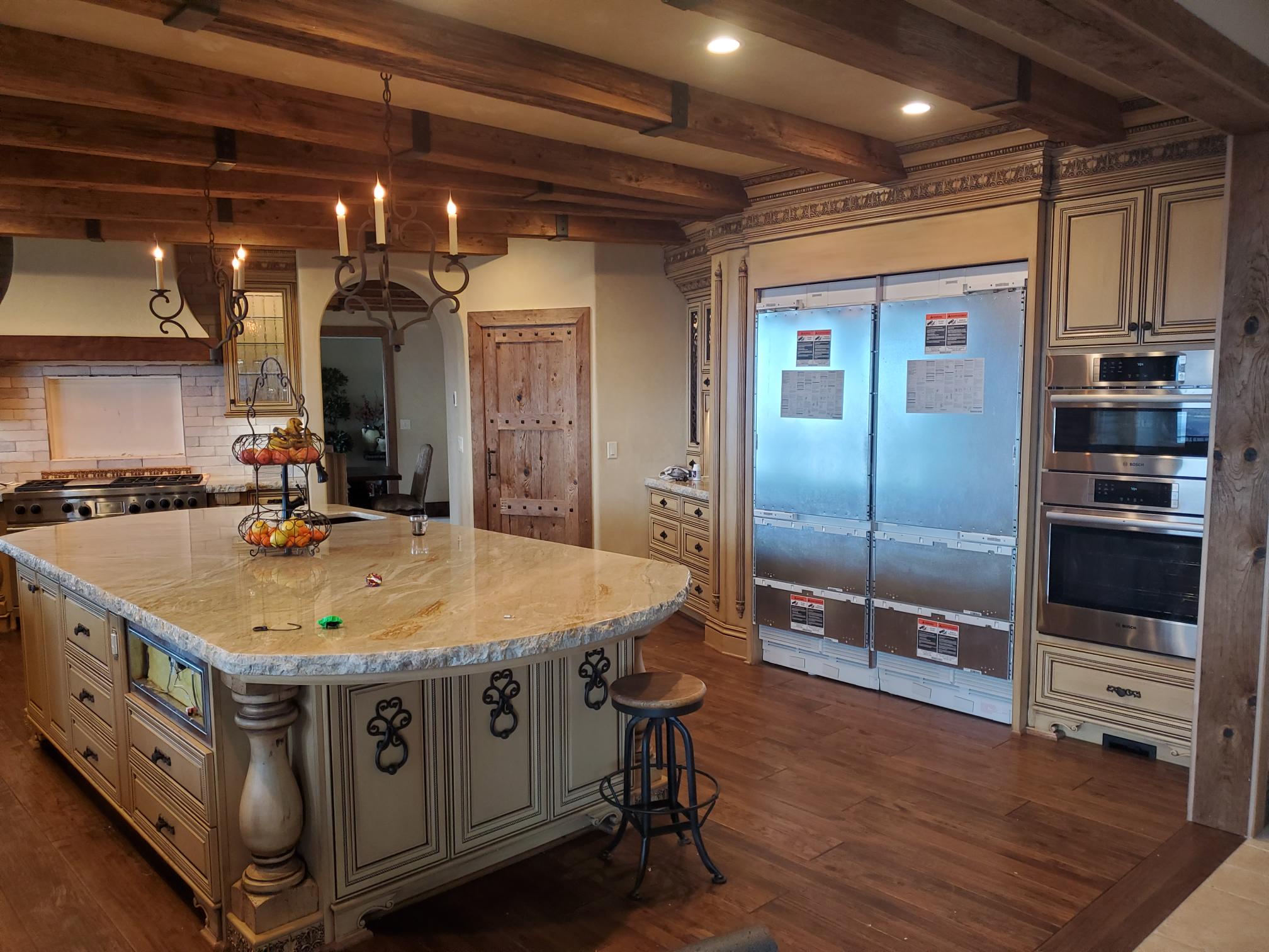 Kitchen island and work areas illuminated by installed lighting
