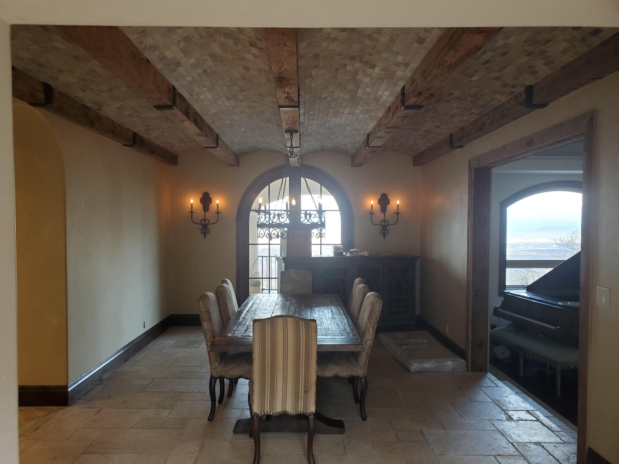 Dining room with ceiling lighting and wall sconces