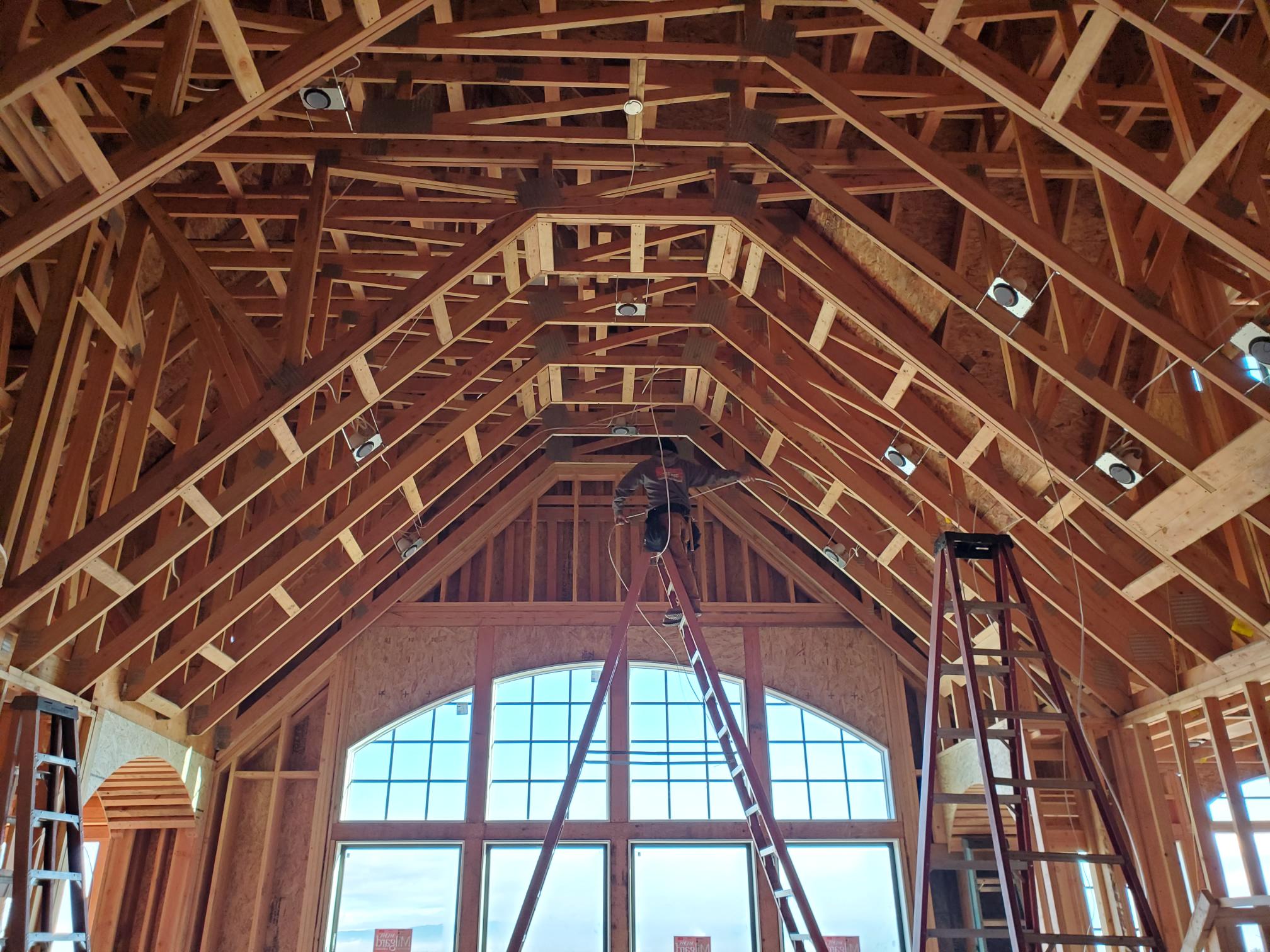 Electrical rough-in underway in an open-framed custom home