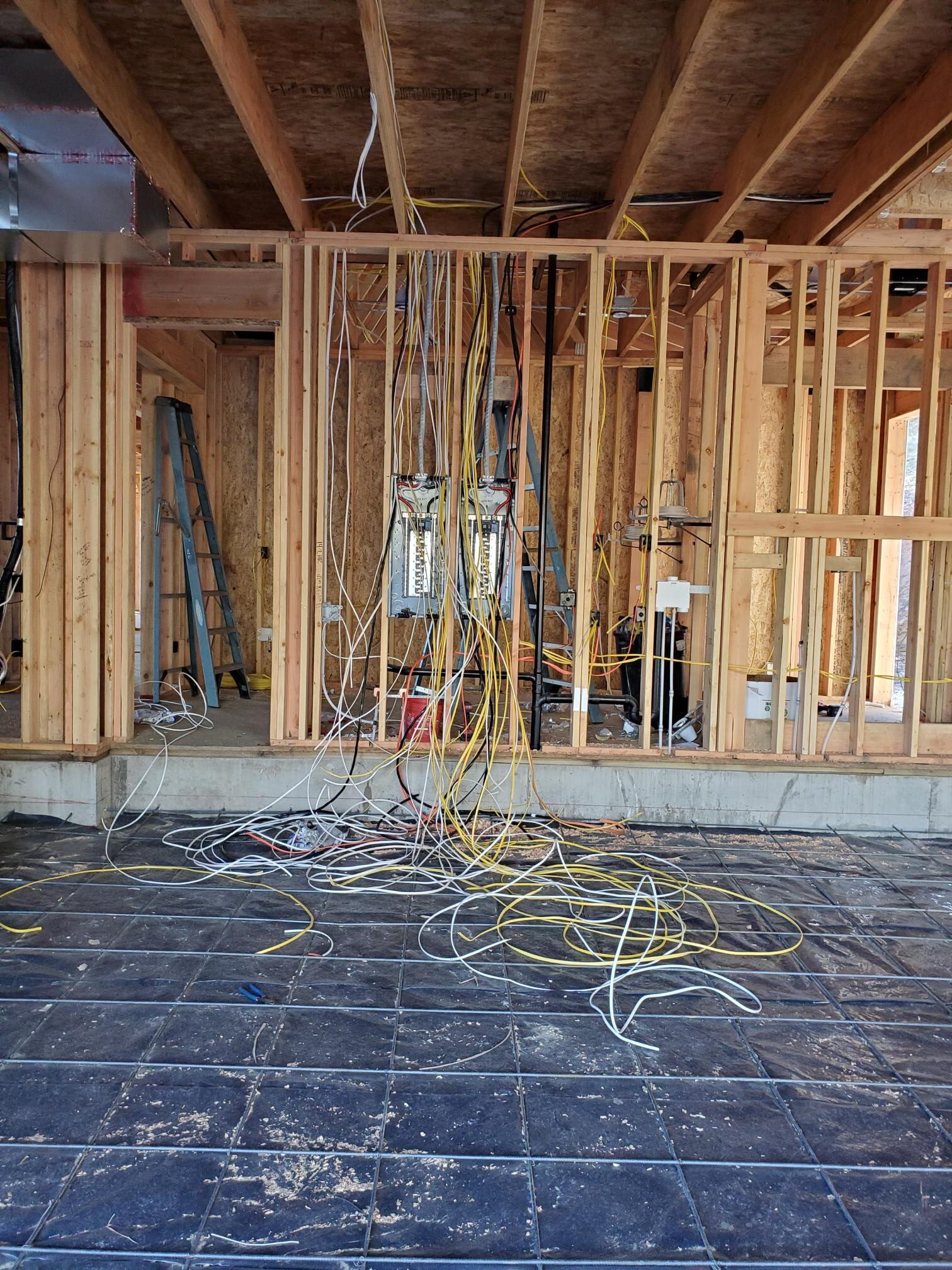 Electrical rough-in wiring routed through open wall framing