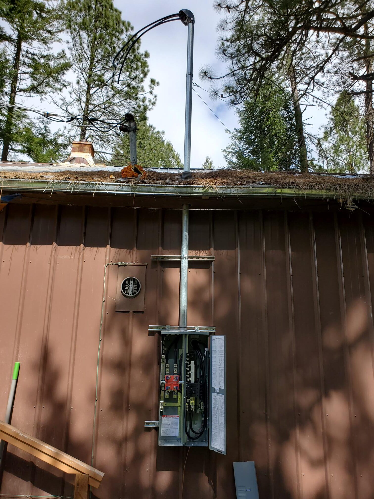 Exterior electrical panel and meter equipment mounted on wood siding