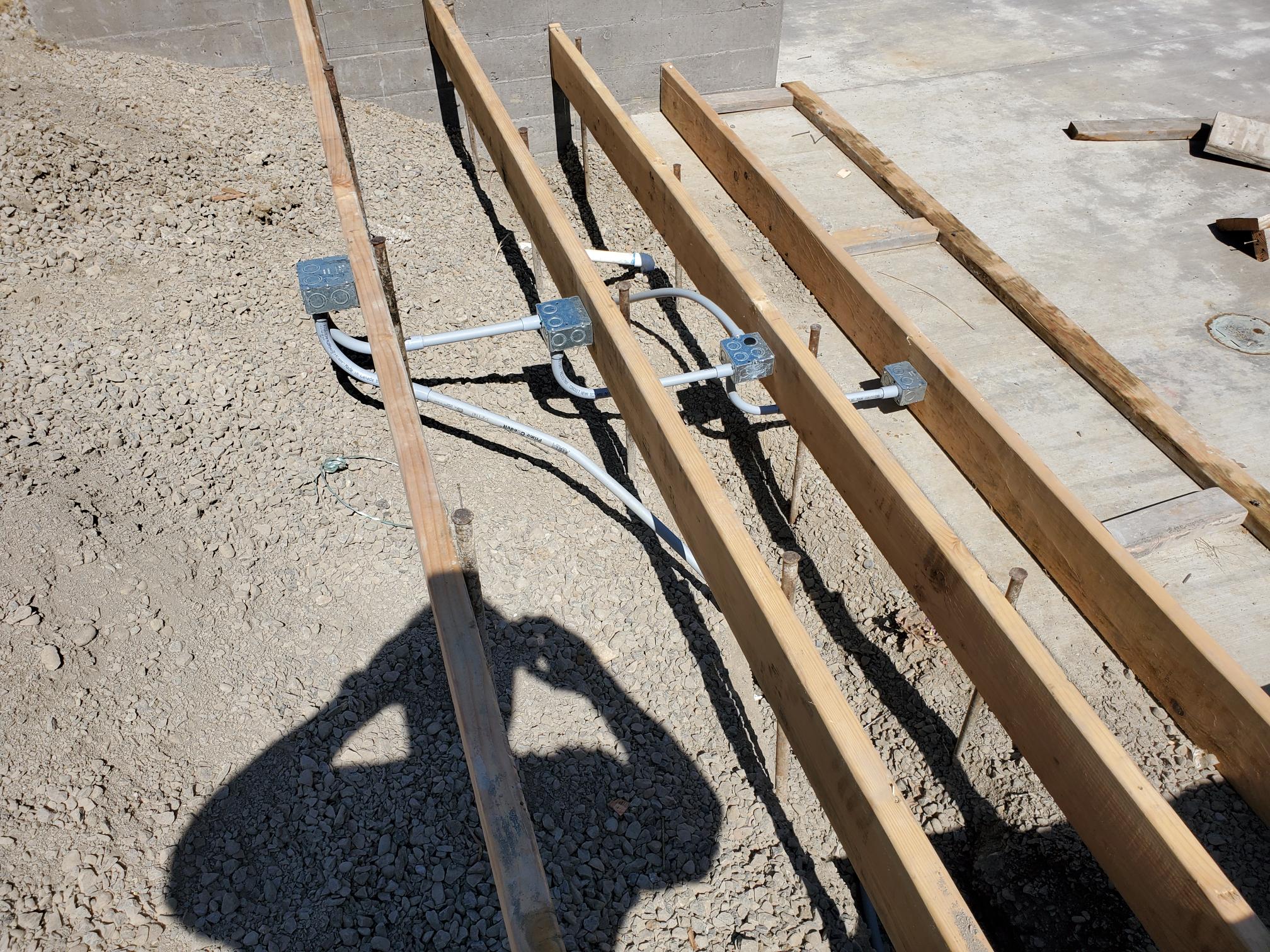 Electrical conduit and junction boxes installed along structural framing