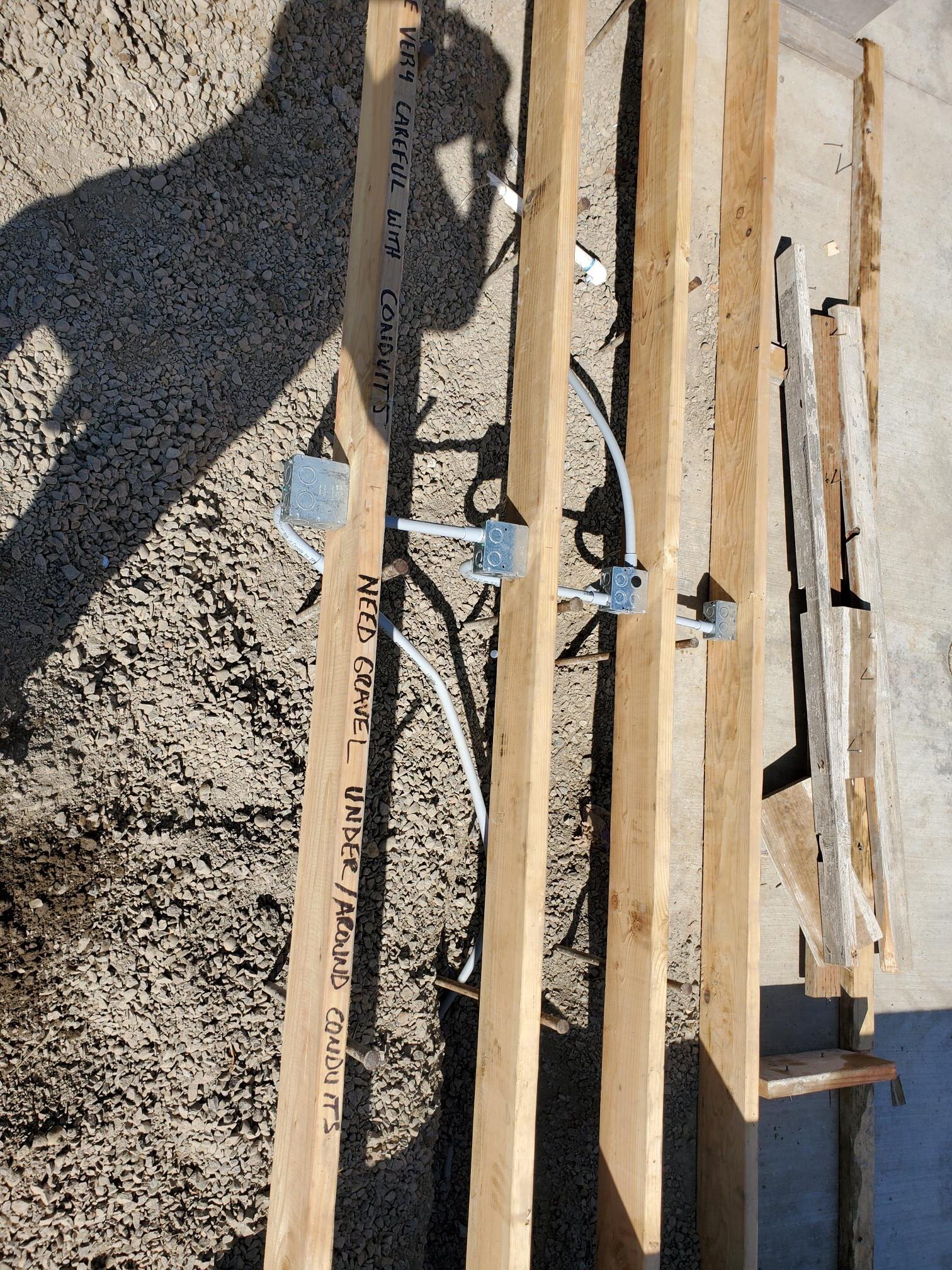 Electrical conduit and boxes installed between floor framing