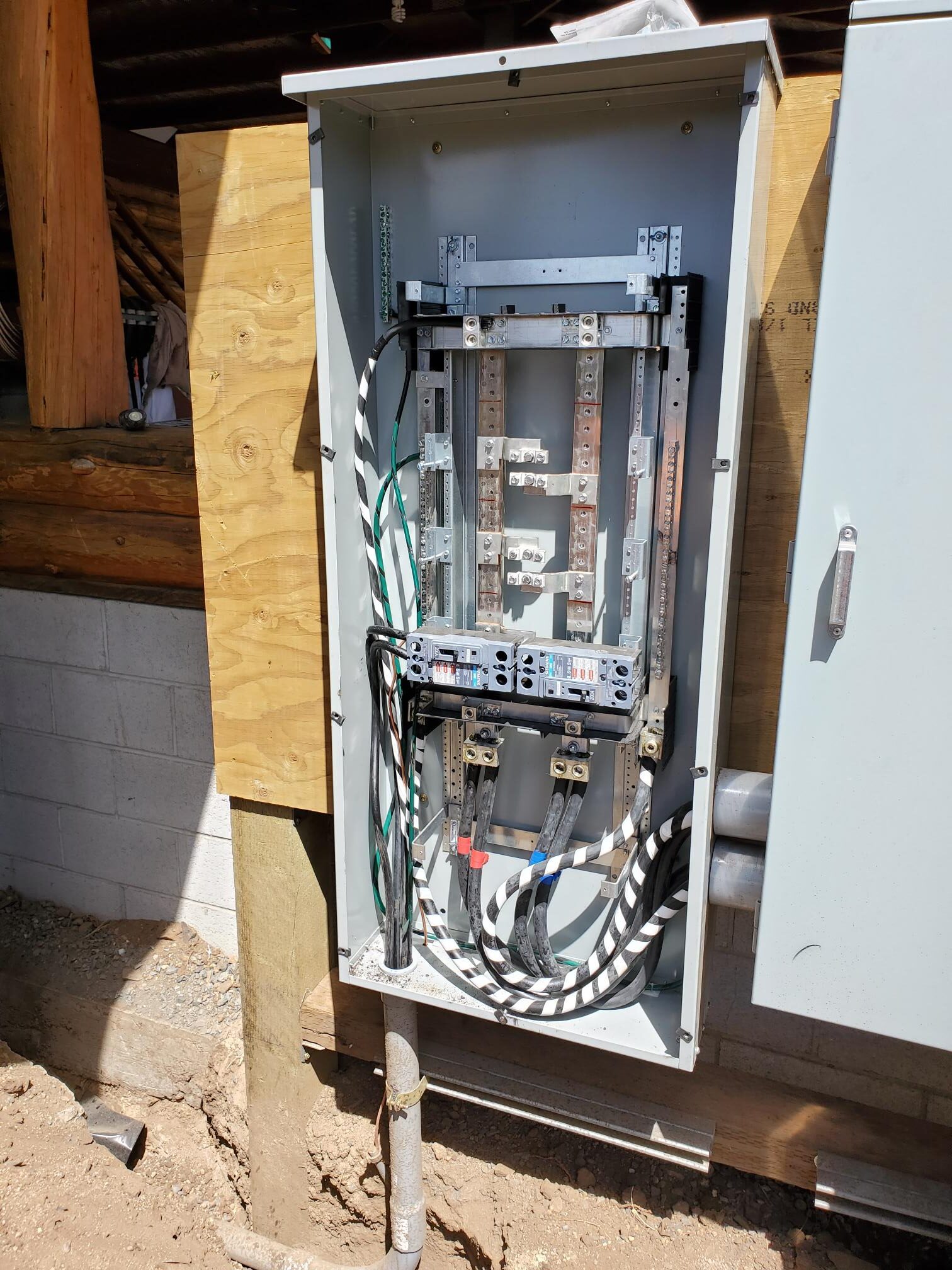 Open electrical panel with breakers and neatly routed conductors